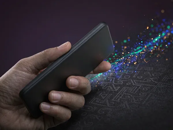 p88 Hand holding a smartphone with colourful light particles